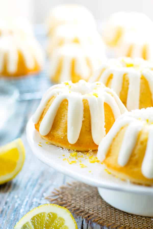 A collection of gluten-free Mini Lemon Bundt Cakes on a cake plate for dessert.