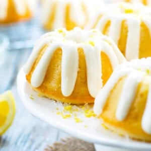 Gluten-free Lemon Bundt Cakes using a lemon bundt cake glaze on a cake plate.