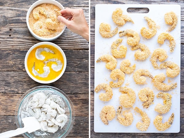 A bowl of shrimp coated in flour, shrimp in an egg wash, and then being dipped in a coconut and bread crumb mixture.