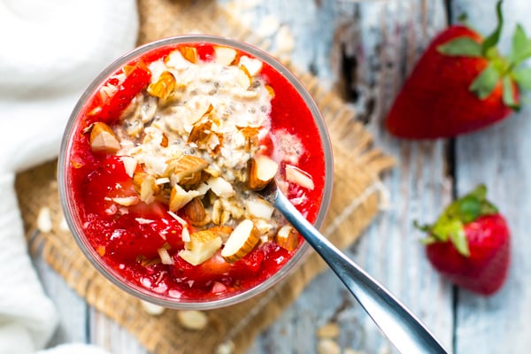 An overhead picture of gluten-free strawberry overnight oats with a spoon.