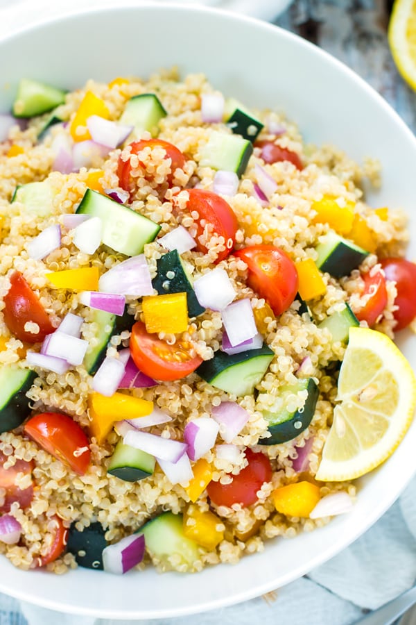 A bowl of gluten-free summer quinoa salad with vegetables for a light dinner.