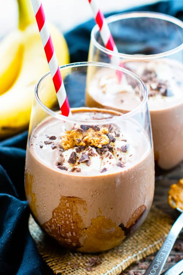 Two glasses of a gluten-free peanut butter smoothie with chocolate and bananas for a healthy breakfast.