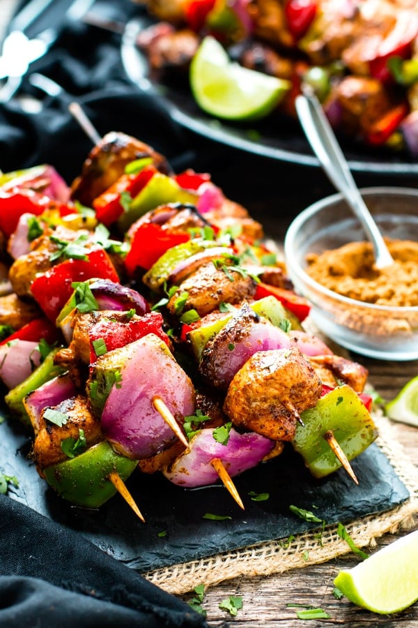 A stack of Grilled Fajita Chicken Kabobs on a blue slab for a healthy lunch.