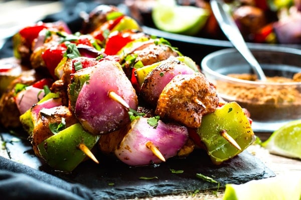 A pile of gluten-free grilled fajita chicken kabobs for a healthy dinner.