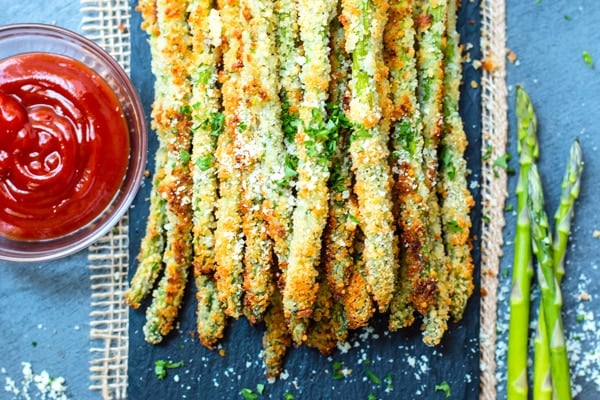 Gluten-free parmesan asparagus fries with a dipping sauce for a quick appetizer.