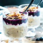 Two servings of Healthy Blueberry Overnight Oats topped with pecans and chia seeds.
