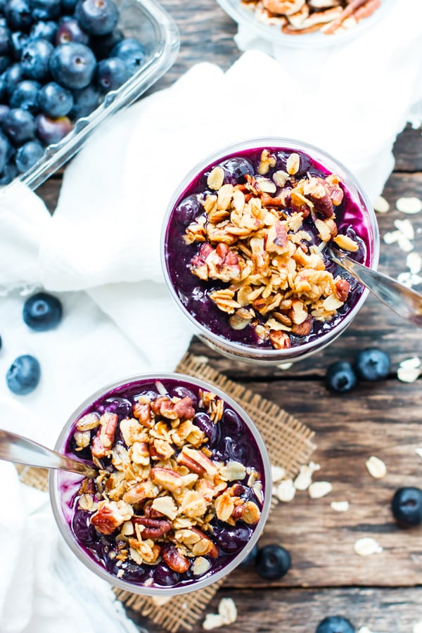 An overhead picture of two cups of gluten-free blueberry overnight oats.
