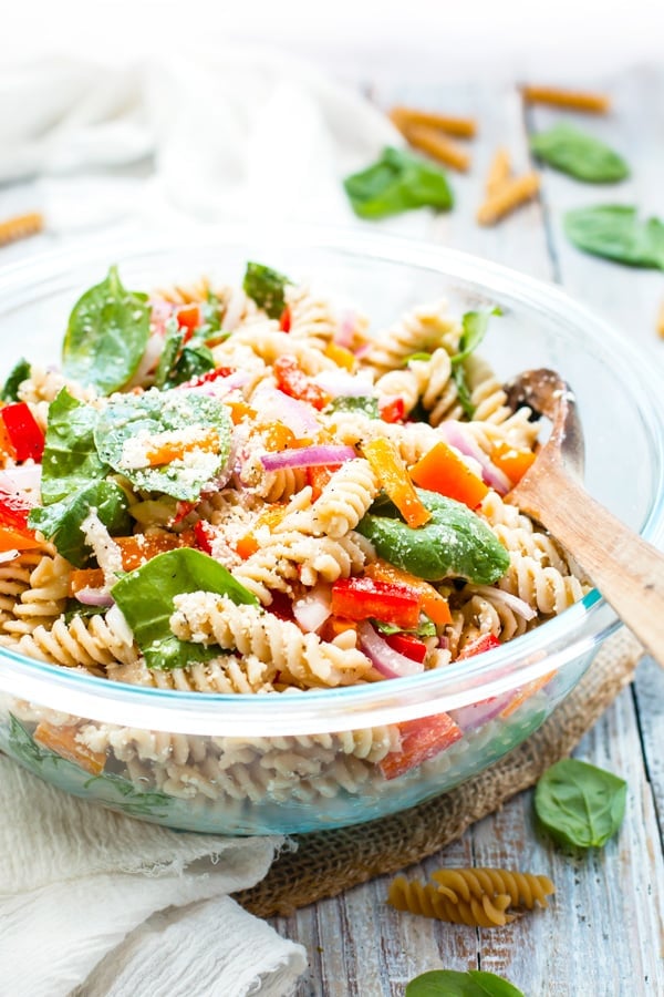 Italian Dressing Pasta Salad made with Parmesan Cheese in a serving bowl on a white napkin.