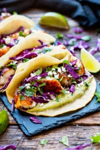 Blackened fish tacos are paired with a refreshing avocado, cilantro and lime sauce for an epic taco combo!  They make a great healthy gluten-free dinner or lunch recipe and can be made with tilapia, cod, or any other white-fleshed fish.
