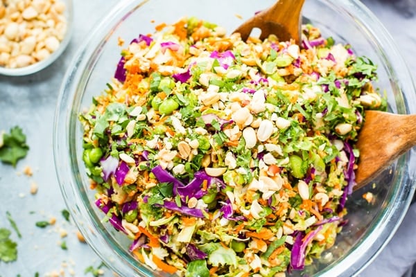 Gluten-free Shredded Brussels Sprouts Salad in a glass bowl.