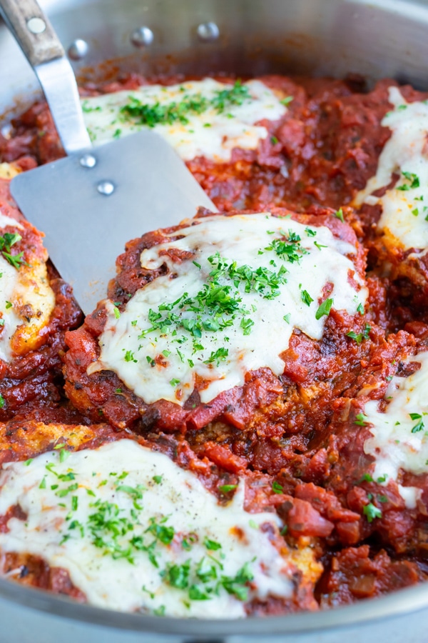 Remove chicken parmesan from the skillet and plate with spaghetti noodles.