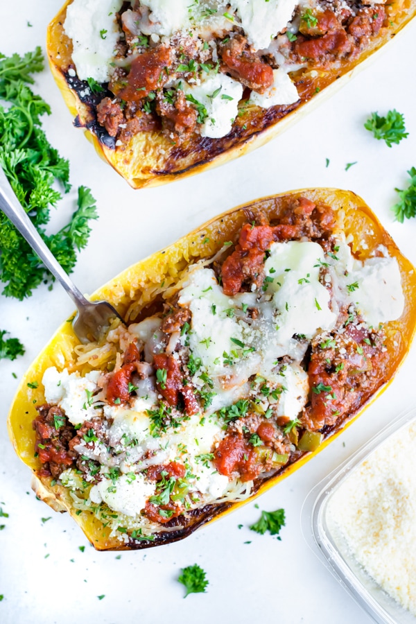 Roasted spaghetti squash is filled with ground turkey, sauce, and cheese in this noodle alternative dish.