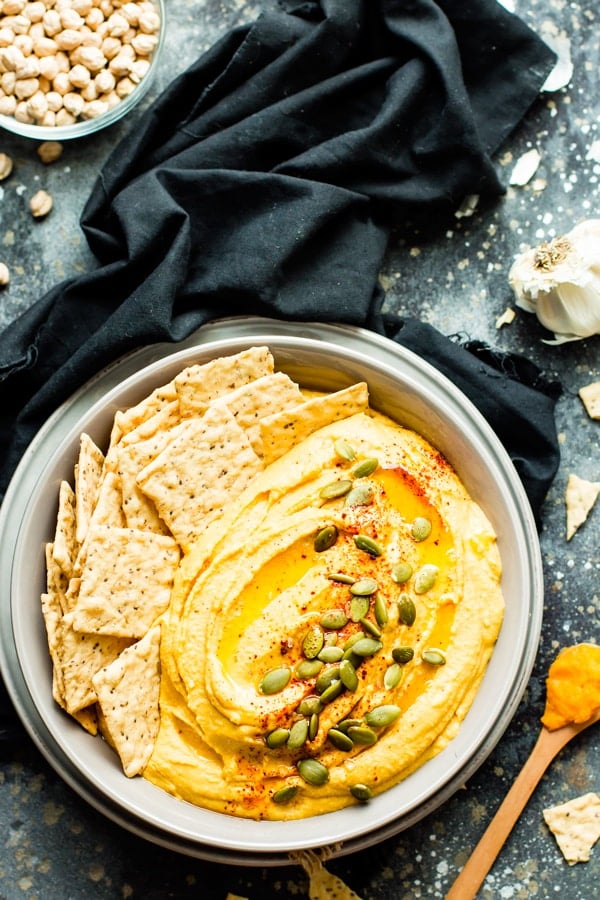 Gluten-free savory pumpkin dip in a bowl with a black napkin.