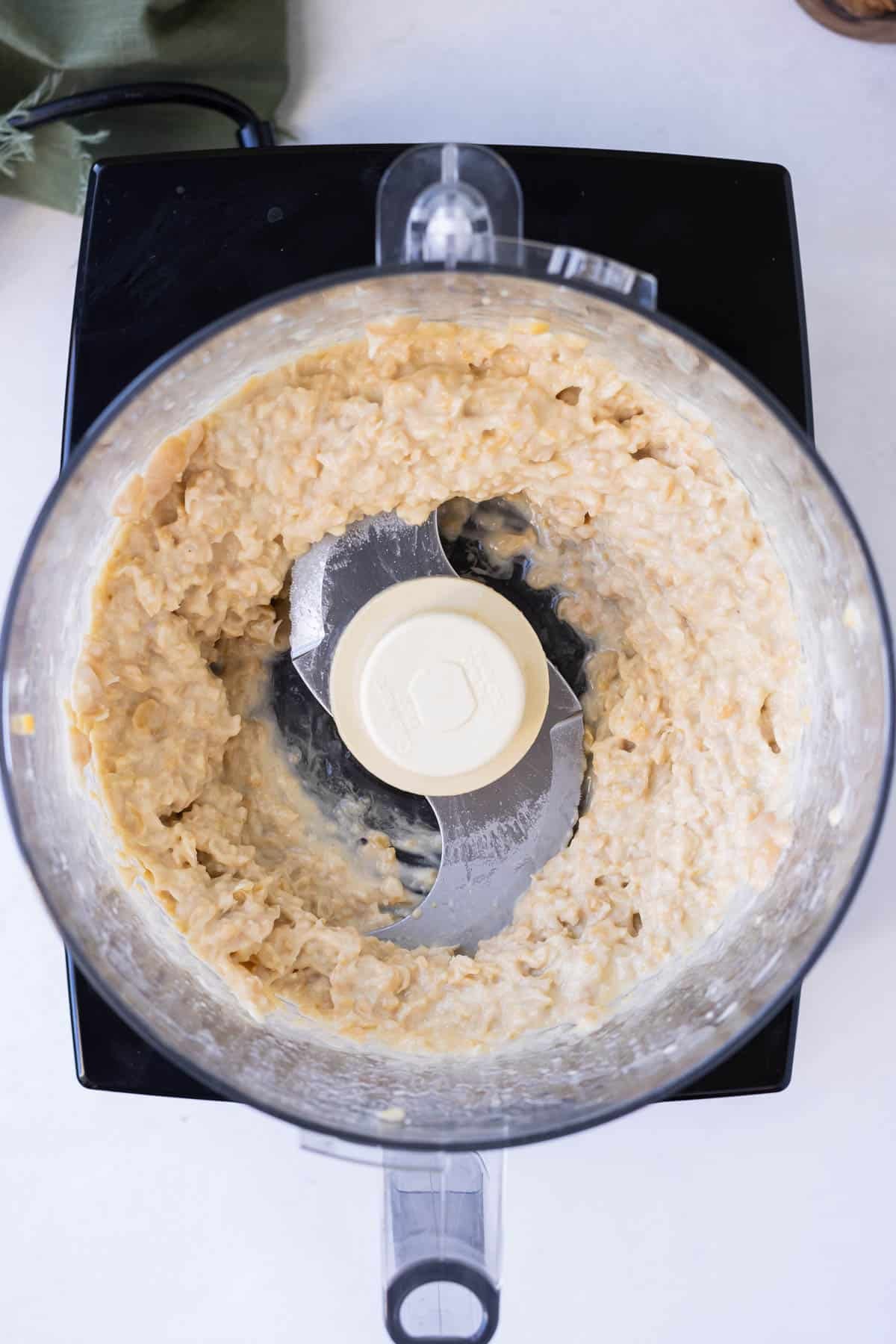 Chickpeas are processed until smooth.