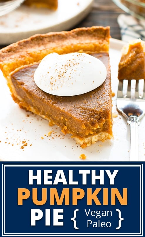 Healthy pumpkin pie with coconut whipped cream on a white plate.