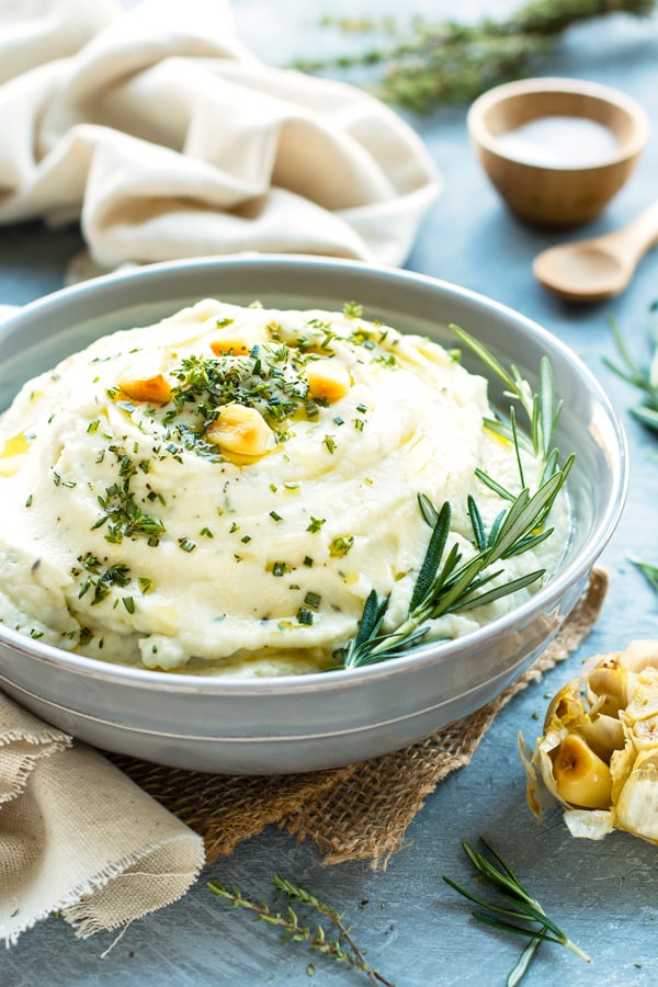 Roasted Garlic Mashed Cauliflower is a wonderful Paleo, vegan, ketogenic, low-carb, and healthier alternative to mashed potatoes.  They are super creamy, loaded with garlic flavor, and are sure to be a hit at your dinner table.  Roasted Garlic Mashed Cauliflower is a healthy Thanksgiving side dish to add to your menu this Fall.