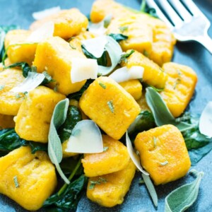 A close up picture of Butternut Squash Gnocchi on a blue plate as a healthy side.