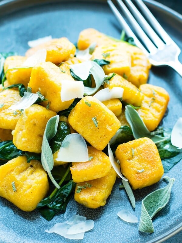 A close up picture of Butternut Squash Gnocchi on a blue plate as a healthy side.