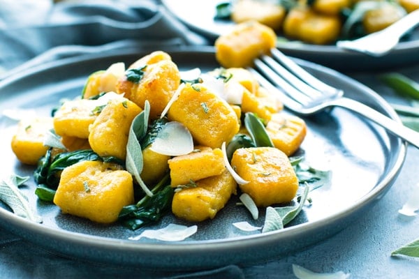 A serving of this gnocchi recipe made with butternut squash with a fork on the side.