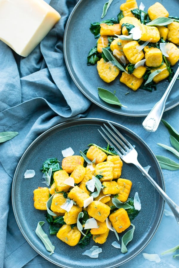 Two blue plates filled with butternut squash gnocchi for a healthy lunch.