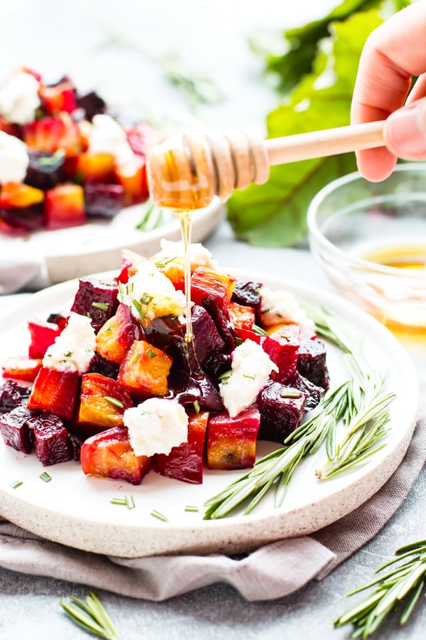 Honey being drizzled over this oven roasted beets recipe.