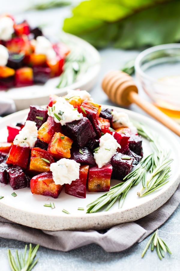 Roasted Beets with Honey Ricotta and Herbs on a white plate for a holiday dinner.
