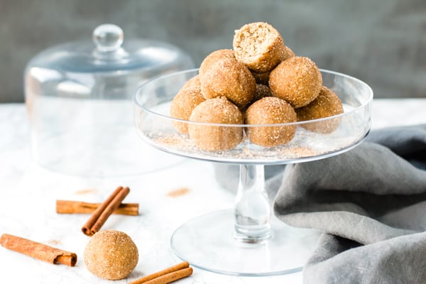 A pile of gluten-free Snickerdoodle Cookie Dough Bites on a glass tray.