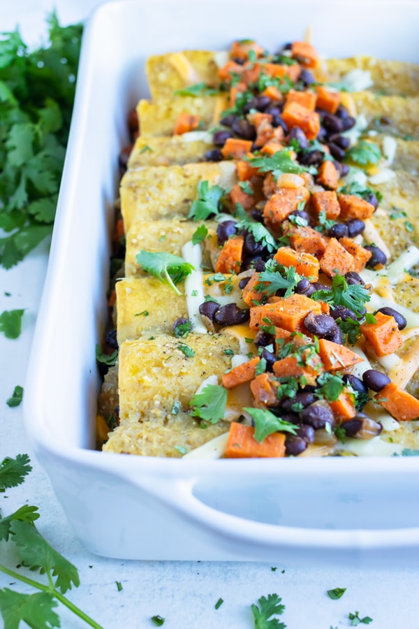 Healthy vegetarian enchiladas are served for a Mexican inspired dinner.