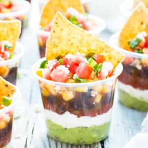 Plastic cups filled with gluten-free 7 layer dip recipes for a party or get together.