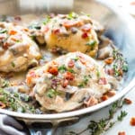 A picture of a delicious chicken mushroom recipe with bacon and herbs in a pan for a healthy lunch.