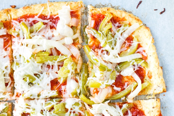 A few pieces of pizza with vegetables using easy cauliflower pizza crust.