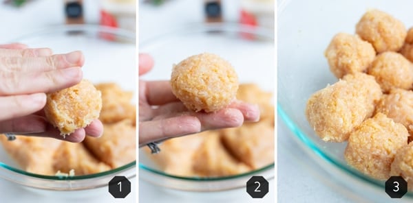 A hand rolling ground chicken mixture into meatballs.