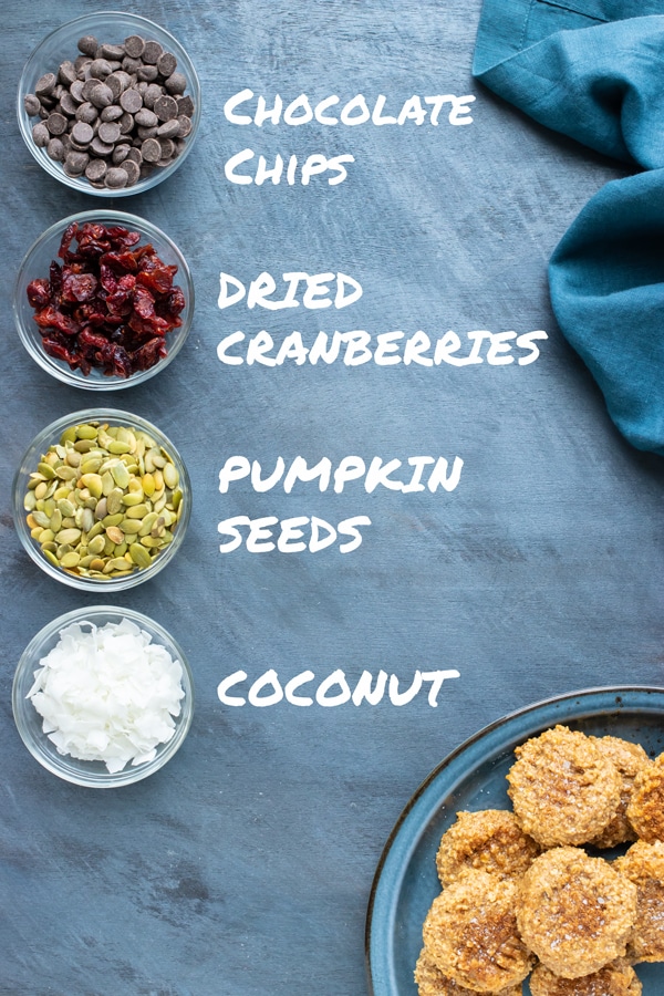 Chocolate chips, cranberries, pumpkin seeds, and coconut as additions to an easy almond butter cookie recipe.