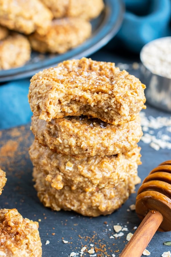 A stack of almond butter oatmeal cookies with a bite taken out.