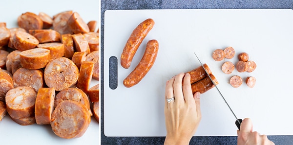Andouille sausage links being cut into bite-sized pieces.