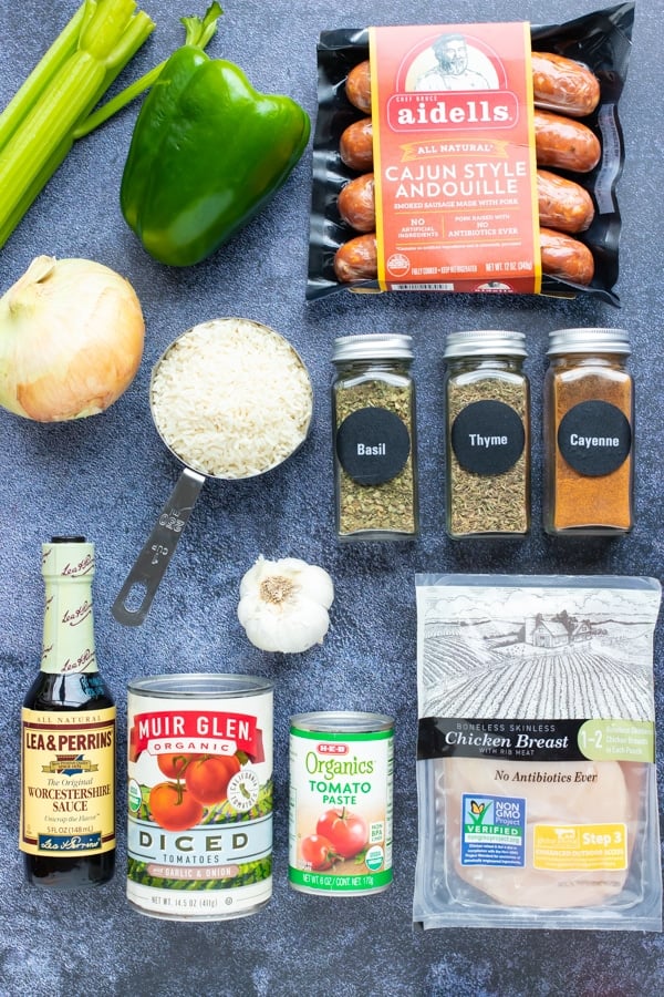 Chicken, andouille sausage, seasonings, tomatoes, onion, celery, bell pepper as the ingredients for a Cajun jambalaya recipe.