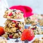 A pile of gluten-free strawberry cookies with oatmeal and chocolate chips with milk.