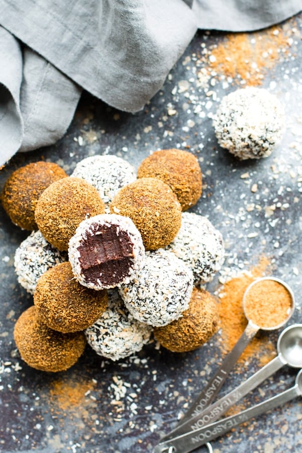 A stack of gluten-free chocolate fudge truffles on a table with a gray cloth.