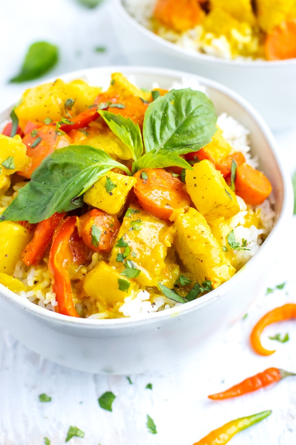A large serving bowl full of Thai yellow curry recipe with chicken and potatoes.