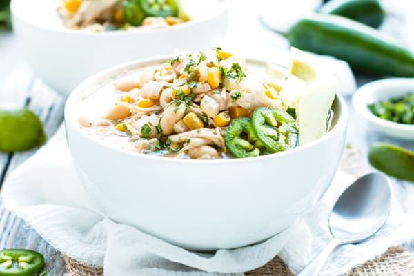 A bowl of white chicken chili made in the crockpot for a healthy dinner.