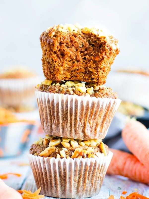 Stacked gluten-free carrot cake muffins recipe on a table.
