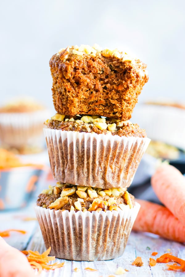 Stacked gluten-free carrot cake muffins recipe on a table.