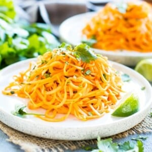 Sweet potato noodles recipe on two white plates for a healthy lunch.