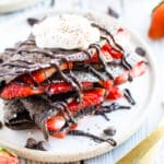 Paleo chocolate crepes recipe on a plate with two forks.