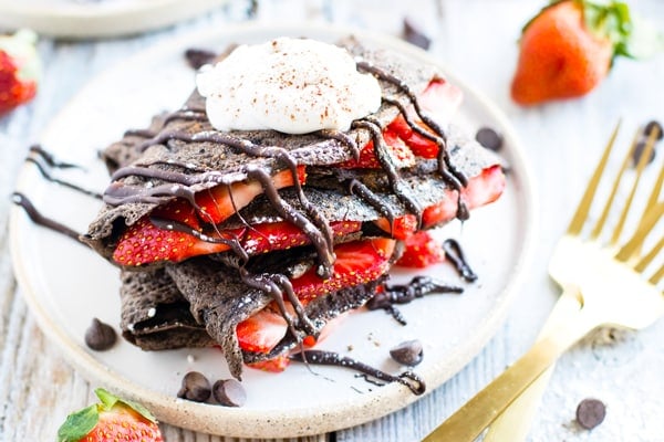 Paleo chocolate crepes recipe on a plate with two forks.