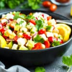 Gluten-free Mediterranean cucumber salad in a black bowl for an easy lunch.