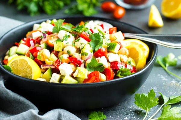 Gluten-free Mediterranean cucumber salad in a black bowl for an easy lunch.