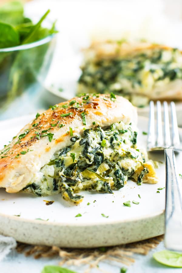 Spinach Artichoke Stuffed Chicken Breast is the perfect combination of your favorite dip and favorite bird, all rolled into one quick and easy Ketogenic stuffed chicken breast recipe! These spinach and mozzarella stuffed chicken breasts are gluten-free, low-carb, and Keto diet-approved!