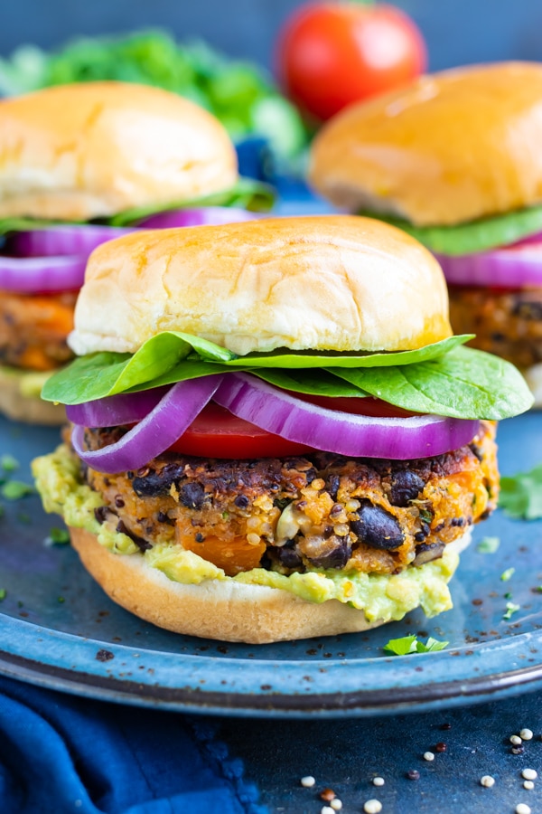 This Sweet Potato Black Bean Burger recipe is made with quinoa, oat flour, and loaded with spices for a healthy and filling veggie burger.   Bake this black bean quinoa burger in the oven, sear it in a skillet, or cook it on the grill.  It's the best gluten-free, vegetarian, and vegan burger option for your summer picnics and barbecues!