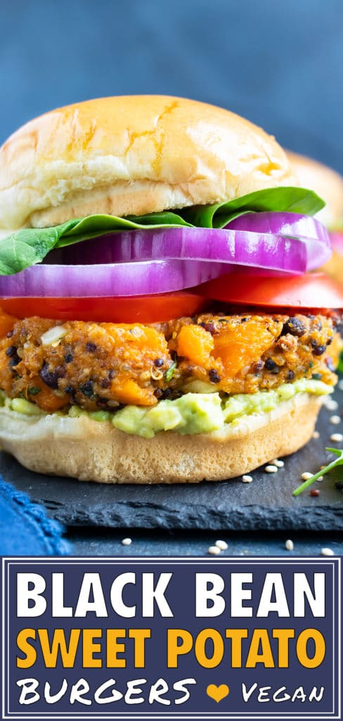 Sweet potato black bean veggie burger patty on a gluten-free bun with red onion, tomatoes, and lettuce.